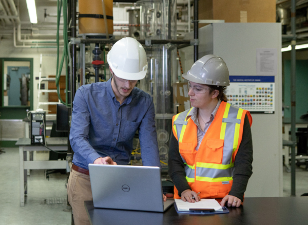 Two technicians consulting a computer