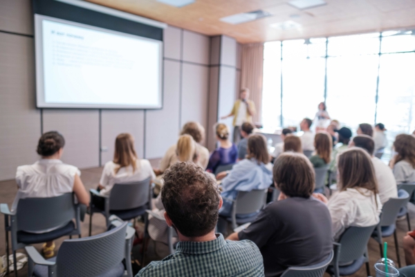 Attendees at a Polytechnic seminar looking at a presentation on a screen
