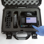 hard travel case for bugcount analyzer, and person's hand pushing a button on the device