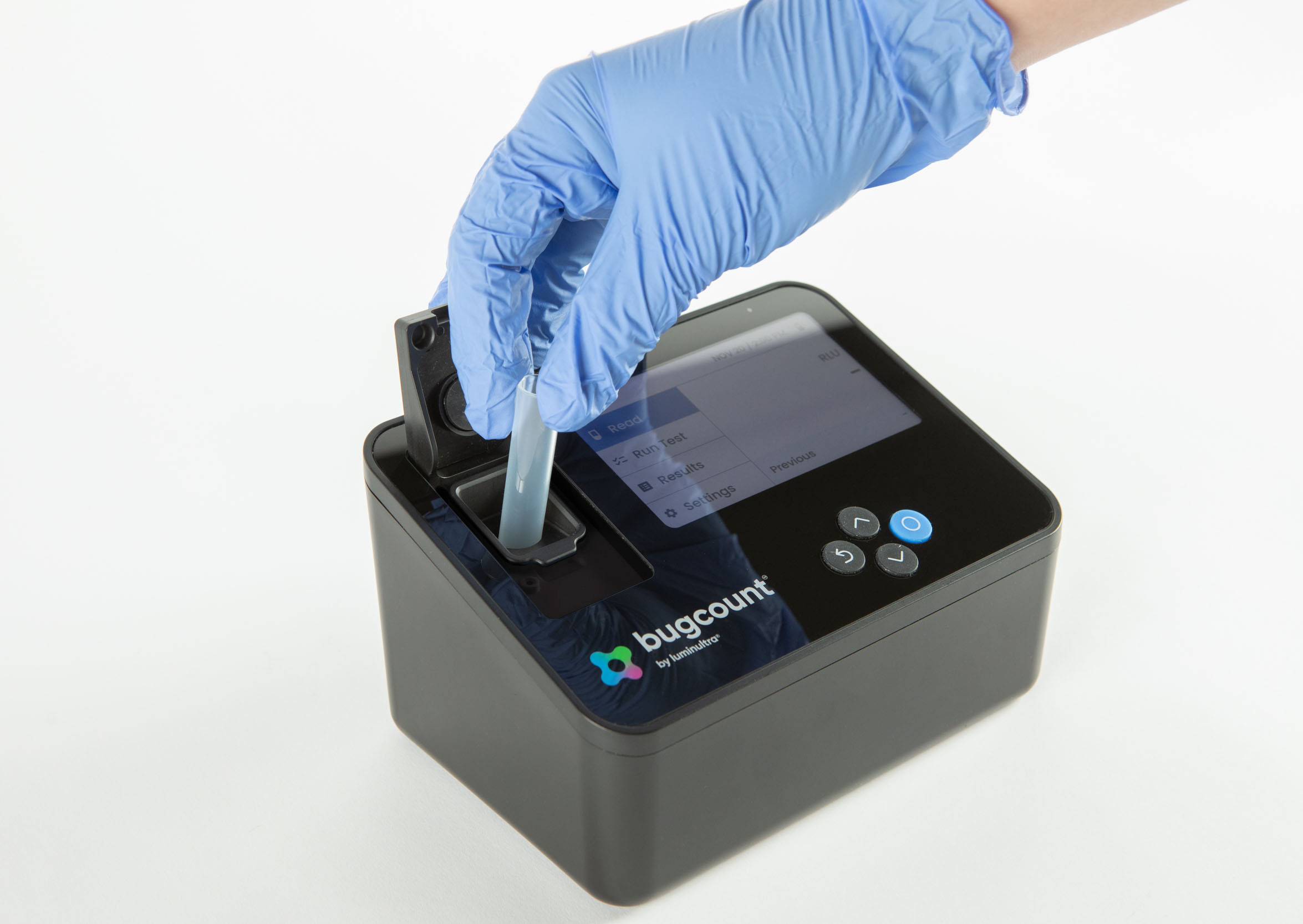 Bugcount analyzer device with gloved hand putting tube into the device for testing
