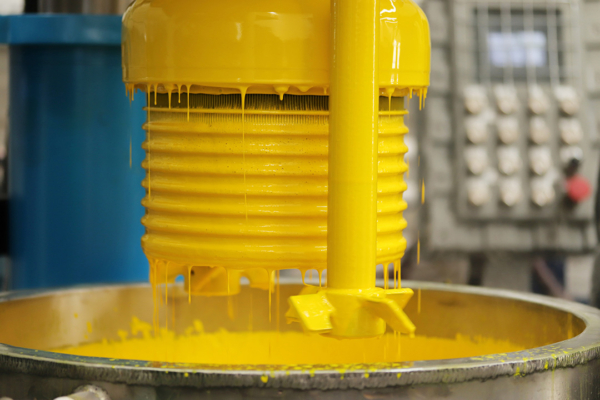 yellow paint in a vat