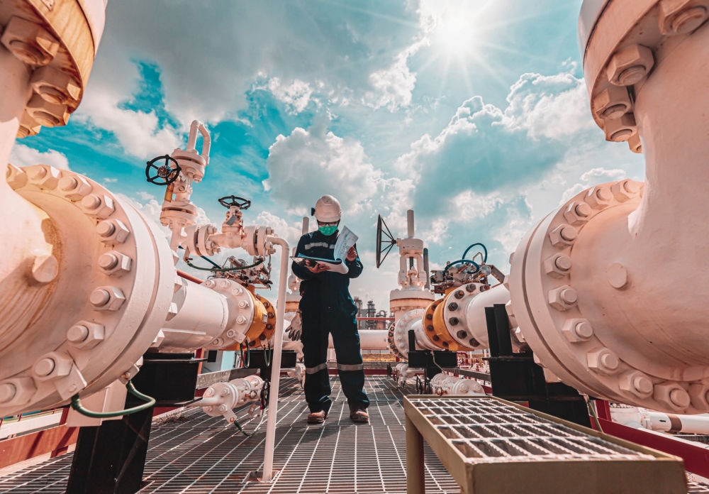 worker inspecting pipelines