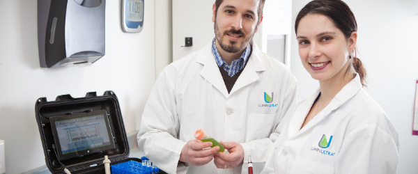 two scientists in a lab in LuminUltra lab coats