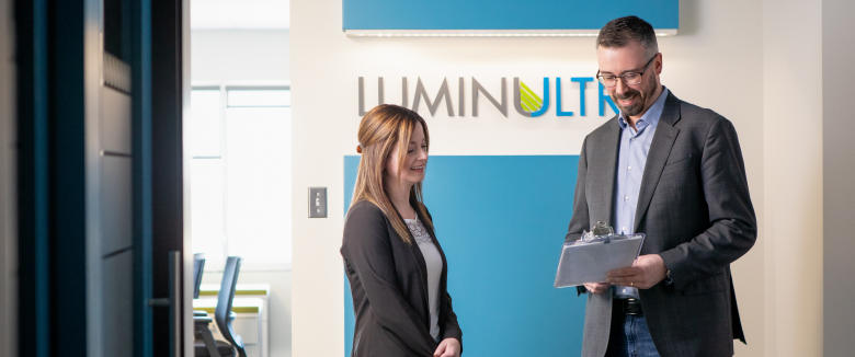 two employees chat in the LuminUltra lobby