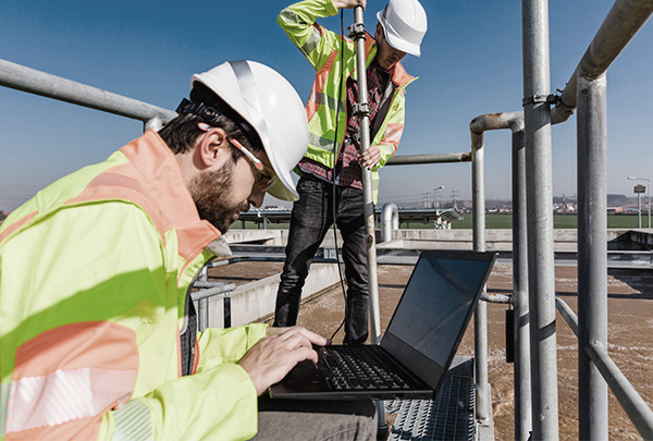 Workers at a wastewater treatment plant